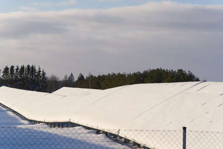 Solar panel field covered with snow. renewable energy in winter low efficiency. renewable green...