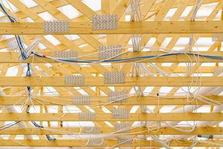 laying of electrical and other engineering systems in a new wooden frame house. building under...