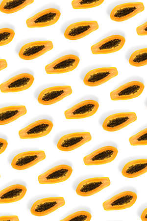 Fresh ripe papaya background on white backdrop. Modern tropical abstract background. Top view. Creative design, minimal flat lay concept. Trend tropical fruit food background - not seamless patternの写真素材
