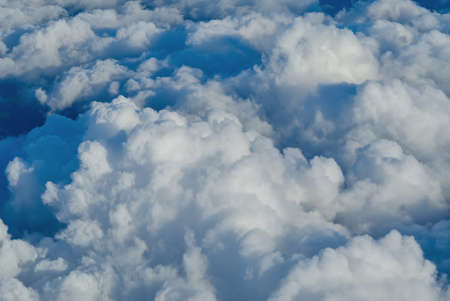 View of the sky above the clouds. blue sky high view from airplane window clouds shapes. sky-clouds...