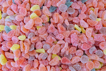 Colorful candy at the candy shop. The colorful background made of dessert jelly. Detail of candy shop. Sweet food arranged on marketの写真素材