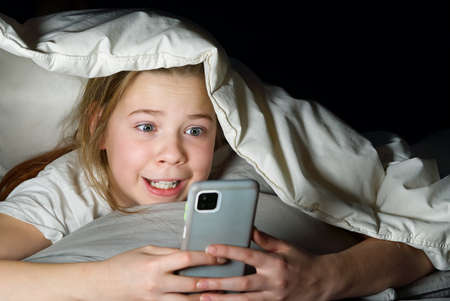 Gadget night. Romantic chat. Late home leisure. Online communication. Portrait of girl with mobile...