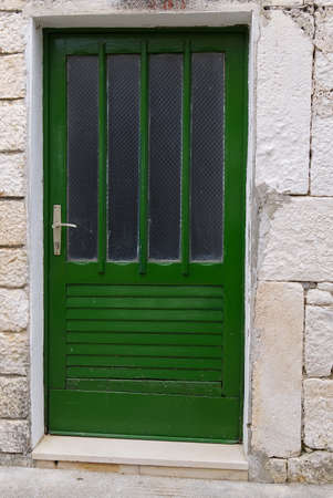 Old entrance wooden green door. Antique wooden green door.の写真素材