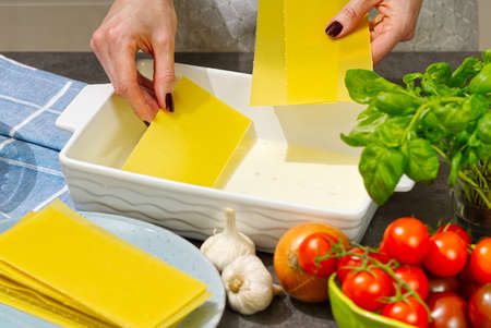 Woman preparing meat lasagna in kitchen. Italian food. lasagna recipeの写真素材
