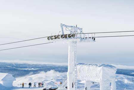 frozen funicular support poles over clouds. ski lift technology in winter, ski resort, mountain resort.の写真素材