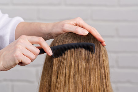 Woman hair care. Hairdresser making hairstyle to young girl in kid beauty salon.