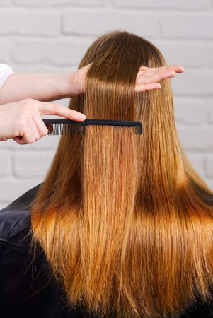 Woman hair care. Hairdresser making hairstyle to young girl in kid beauty salon.