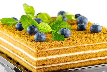 Honey cake with berries close up. Honey cake with blueberries and mint