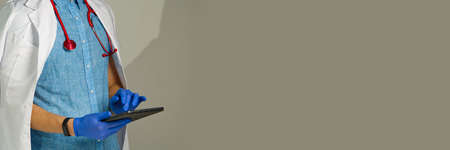 unrecognizable young man doctor standing over light background.の写真素材