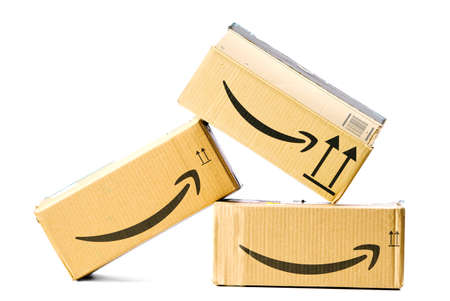 Tallinn, Estonia - March, 2022 : Stack of Amazon Prime parcels over white background. Amazon for faster delivery of orders.のeditorial素材