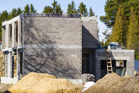 Single Family Home Construction. Interior frame of new wooden house under construction. house under construction with the roof structure of wood. construction frame house made of wood, with roof rafters metal, profiledの写真素材