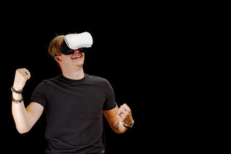 Portrait of a young man with 3D virtual reality glasses. Young man using white virtual reality...