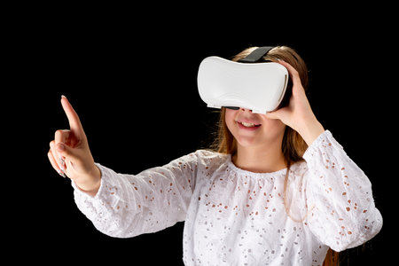 Young woman wearing VR glasses and interacting with virtual reality, entertainment, education and...
