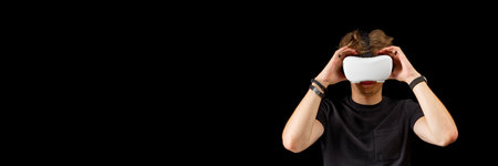 Portrait of a young man with 3D virtual reality glasses. Young man using white virtual reality...