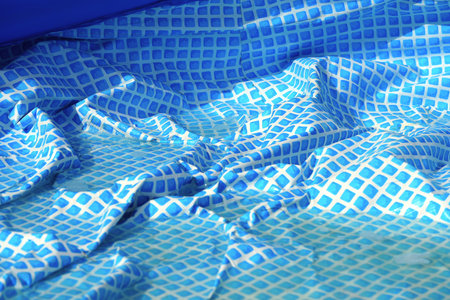 Cleaning pvc inflatable swimming pool, Cleaning the dirty empty pool of algae, The beginning of the swimming season in the hot summer. Cleaning service concept.の写真素材