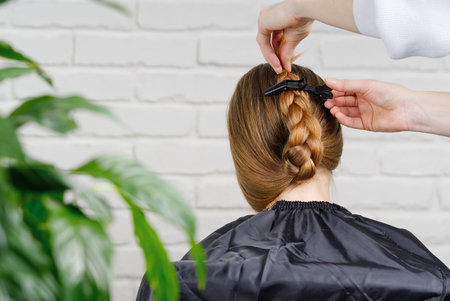 Beautiful girl with long hair. creating a hairstyle for a young unrecognizable girl. Hair styling process.の写真素材