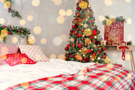 Christmas themed decorated room in light colors with bad and Christmas tree. postcard, background. Christmas themed photo zone in studioの写真素材
