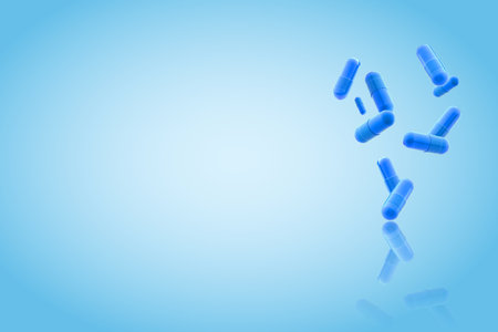 blue medical gel capsules falling down on blue background. food supplement, pharmacy concept. pills
