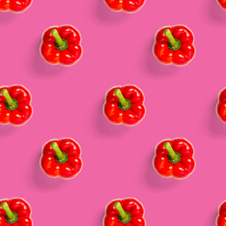 seamless pattern of bulgarian red pepper on pink background. wallpaper, print pattern, top view, flat layout, isolatedの写真素材