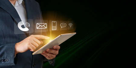 Contact us Businessman holding mobile smartphone with mail phone email icons cutomer support conceptの写真素材