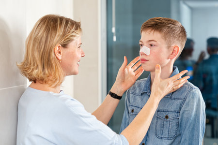 mom glues a patch to remove blackheads to her son. acne remover patchの写真素材