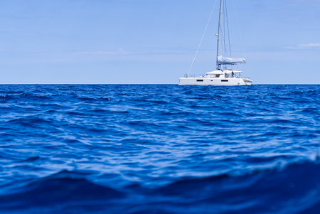 Yacht catamaran on the sea. Catamaran sailing on turquoise waters. Holiday or vacation at seaの写真素材