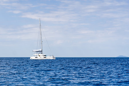 Yacht catamaran on the sea. Catamaran sailing on turquoise waters. Holiday or vacation at seaの写真素材