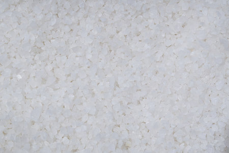 Coarse rock salt texture. Background from white sea salt.