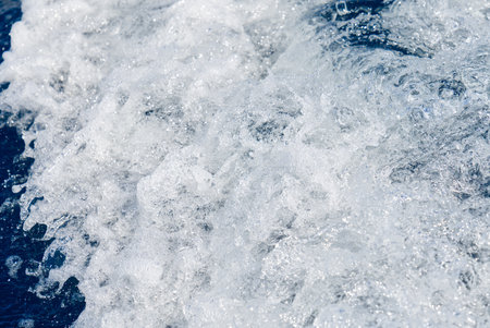 Abstract blue sea water with white waves. Blue sea texture with waves and foam. Mediterranean seaの写真素材