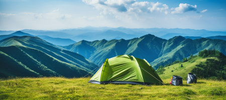 Breathtaking mountain campsite with cozy tent in the foreground on a sun drenched summer dayの素材