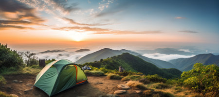 Sunny summer day at picturesque mountain campsite with colorful tent in the foregroundの素材