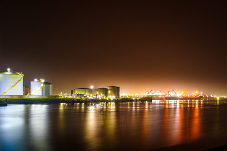 Misty Evening View of Rotterdam Port in the Glowing Night Lightsの写真素材