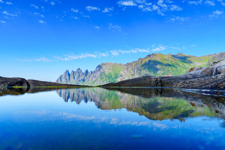 Spectacular Norwegian Summer Day: Fairytale Landscape of Sea, Mountains, and Sky Reflectionの写真素材