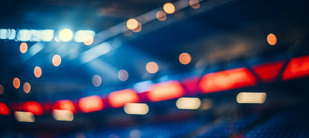 Blurred bokeh effect  vibrant sports stadium with cheering fans in bright lights and blurred actionの素材