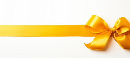 Golden ribbon bow with long straight ribbon for festive banner isolated on white backgroundの素材