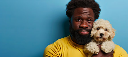 Man bonding with adorable small dog puppy, enjoying sweet moments together in indoor studio setting.の素材