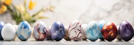 Colorful easter eggs with marble ornaments on white background   copy space for text placementの素材