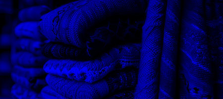 Close up handwoven tapestry  vibrant intricate patterns with bright lightingの素材