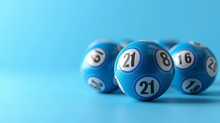 Close up of blue lottery balls on pastel background with focus on lucky number 21の素材