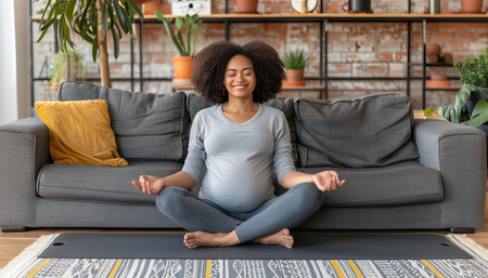 Pregnant woman relaxing on yoga mat at home, copy space available for text placementの素材