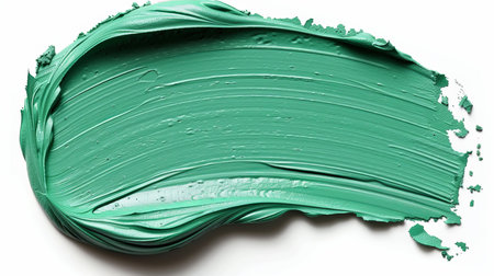 Teal paint stroke isolated on white background for artistic and design projects with copy spaceの素材
