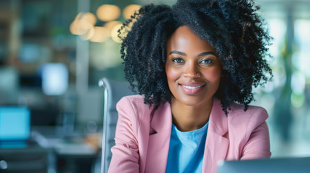 Professional businesswoman in wheelchair smiling while working in a modern office environmentの素材