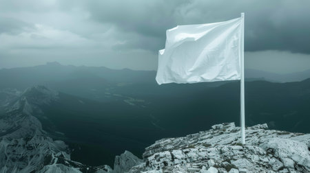 Mountain summit white flag waving on blurred background, symbol fluttering in the windの素材