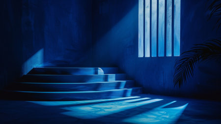 Minimalist blue podium with stone wall and leaf showcasing summer fashion in a luxurious setting.の素材