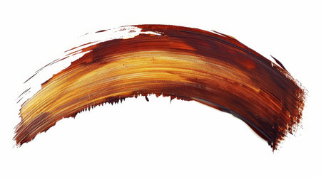 Brown paint stroke isolated on white background for design projects and artistic creationsの素材