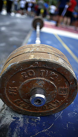Intense focus  barbell with stacked weights showcasing athletic strength in summer olympicsの素材