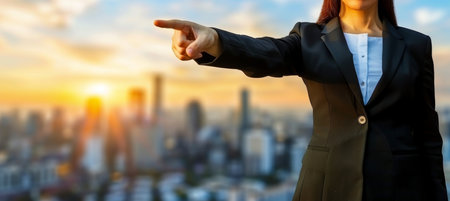 Female business professional pointing in motivational gesture, inspiring conceptの素材