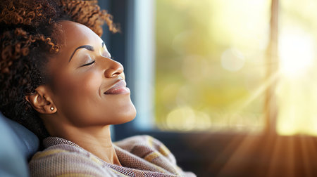 Smiling woman with curly hair gazing out of a window, exuding joy and contentmentの素材