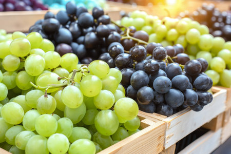 Vibrant grapes in wooden crates  cozy warehouse setting for rustic food advertisementの素材