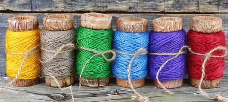 Assorted colorful cotton threads on spools for sewing and intricate embroidery projectsの素材